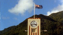 Old clock tower with flag on the top