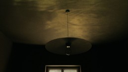 An image of a light fitting in a darkened room
