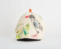 tea cosy with a sea bird painted on it