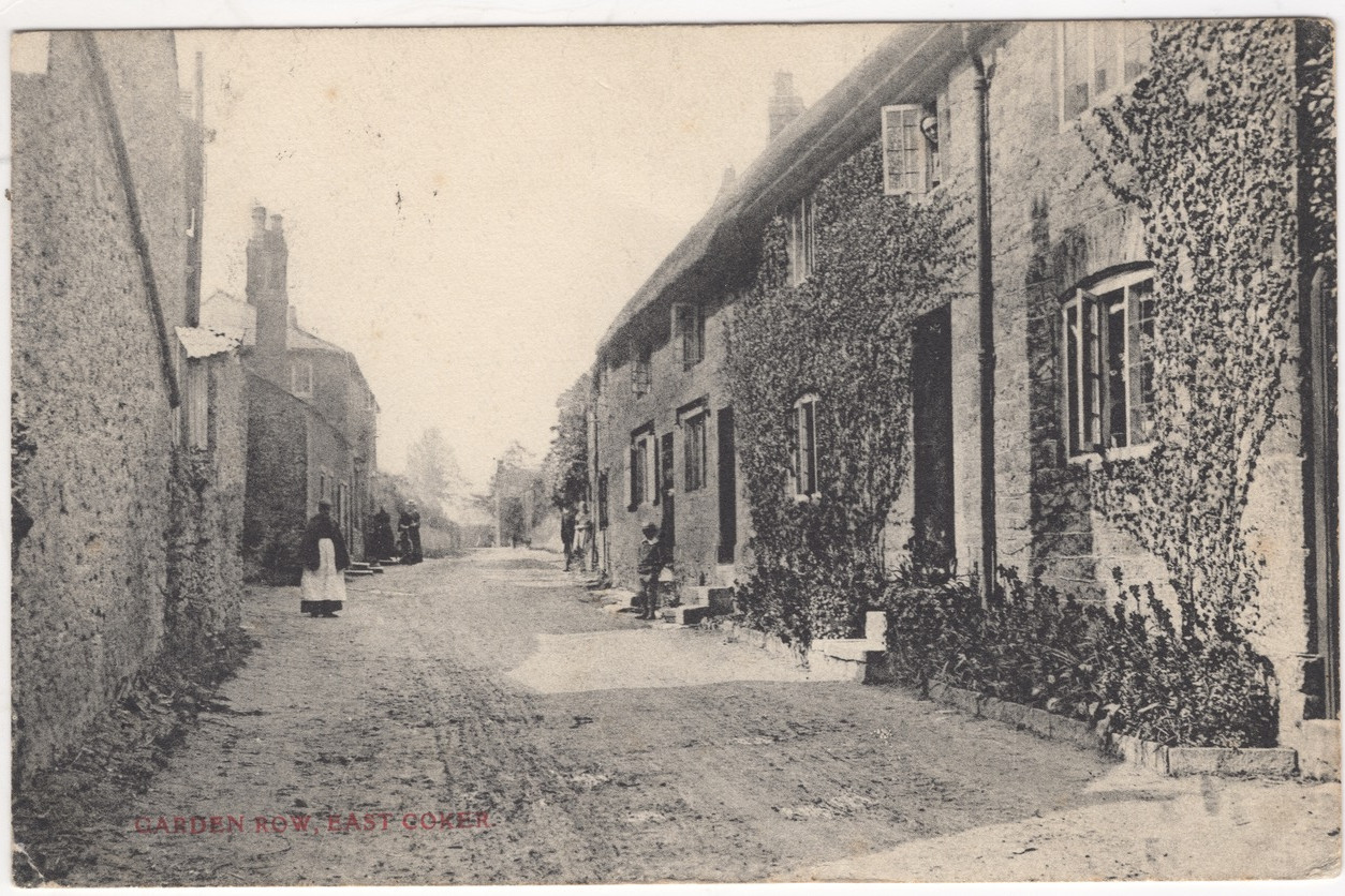 black and white old image of Burton in East Coker, a lone figure standing in the road