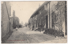 black and white old image of Burton in East Coker, a lone figure standing in the road